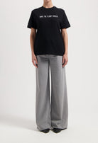 Sustainable MUD Jeans in dark brown, crafted with ethical materials, shown in a slim fit, paired with a casual white tee.