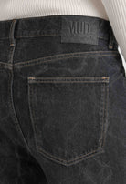 Back view of dark gray MUD Jeans made from organic cotton, highlighting sustainable material and leather logo patch.