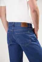 Sustainable MUD Jeans in dark gray denim with a classic fit, promoting ethical fashion and eco-friendly practices.