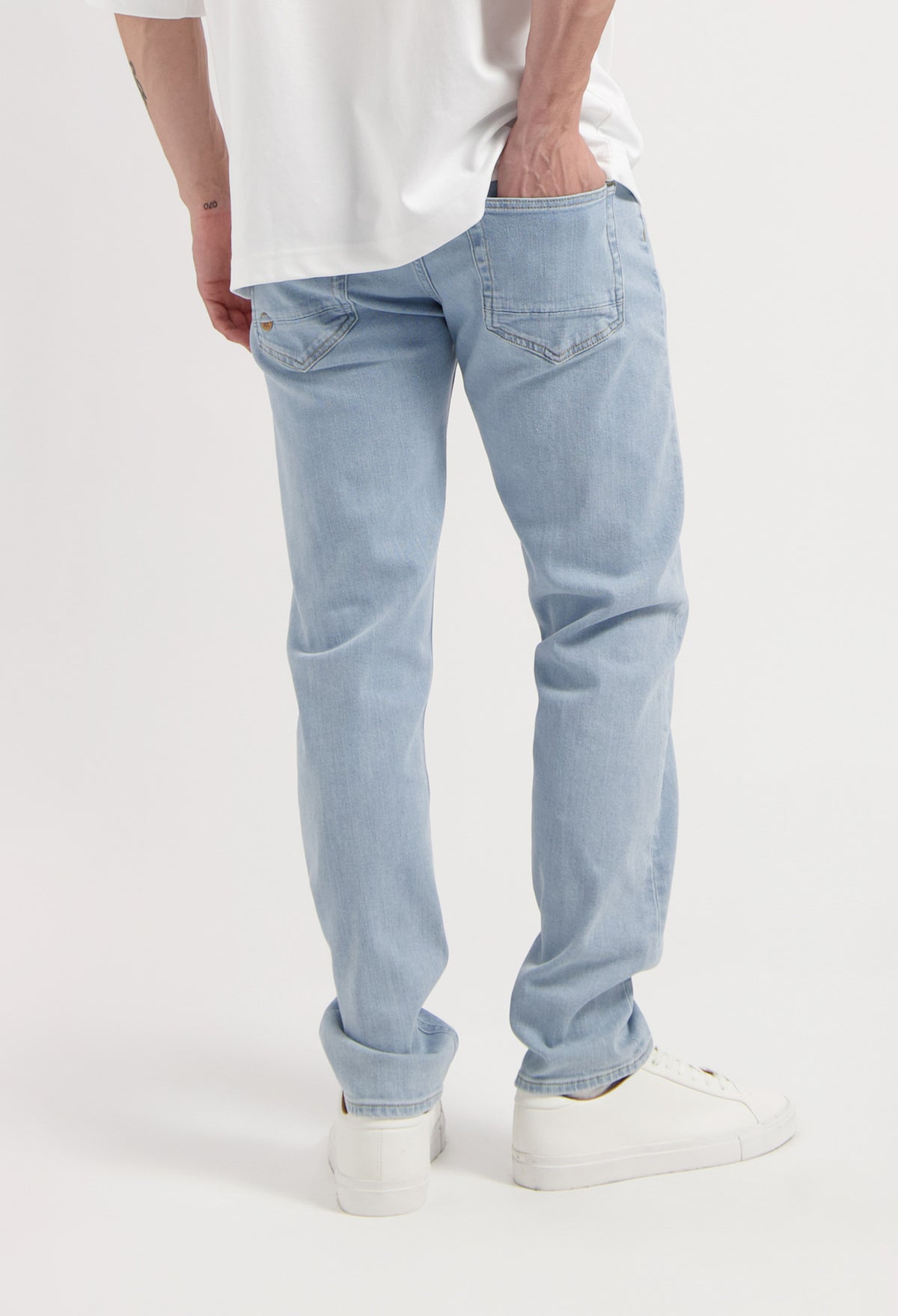 Sustainable MUD Jeans in black denim, showcasing ethical fashion with classic back pockets and minimalist design.