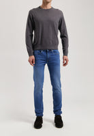 Sustainable MUD Jeans in classic blue denim, made from organic cotton, showcasing ethical fashion and eco-friendly craftsmanship.
