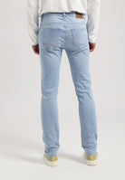 Sustainable MUD Jeans made from organic cotton, in a dark blue wash, paired with a classic gray sweater for an ethical style.