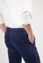 Sustainable MUD Jeans in dark gray denim, crafted ethically, showcasing a slim fit style paired with black sneakers.