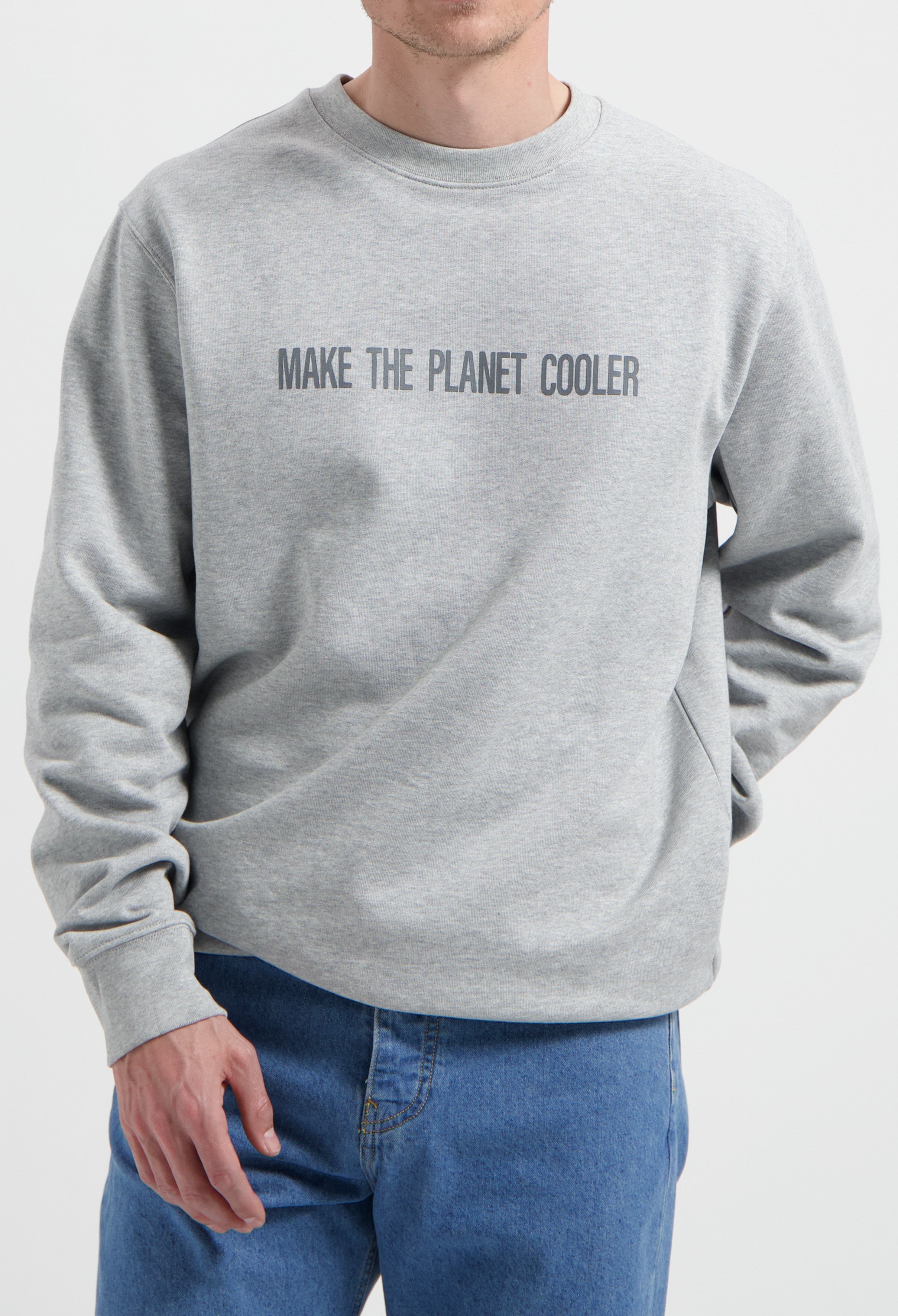 Sustainable MUD Jeans in blue denim paired with a gray ethical sweatshirt with "Make the Planet Cooler" text.