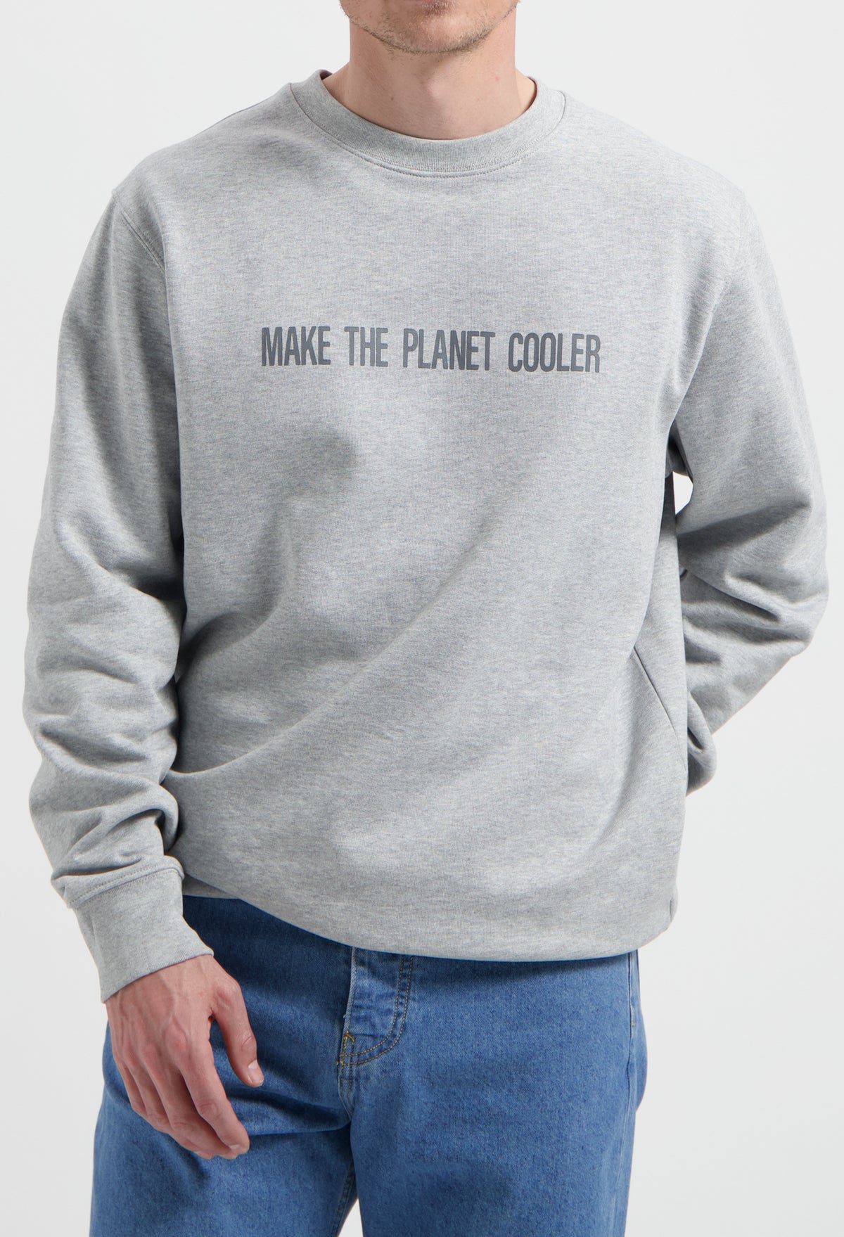 Sustainable MUD Jeans in blue denim paired with a gray ethical sweatshirt with "Make the Planet Cooler" text.