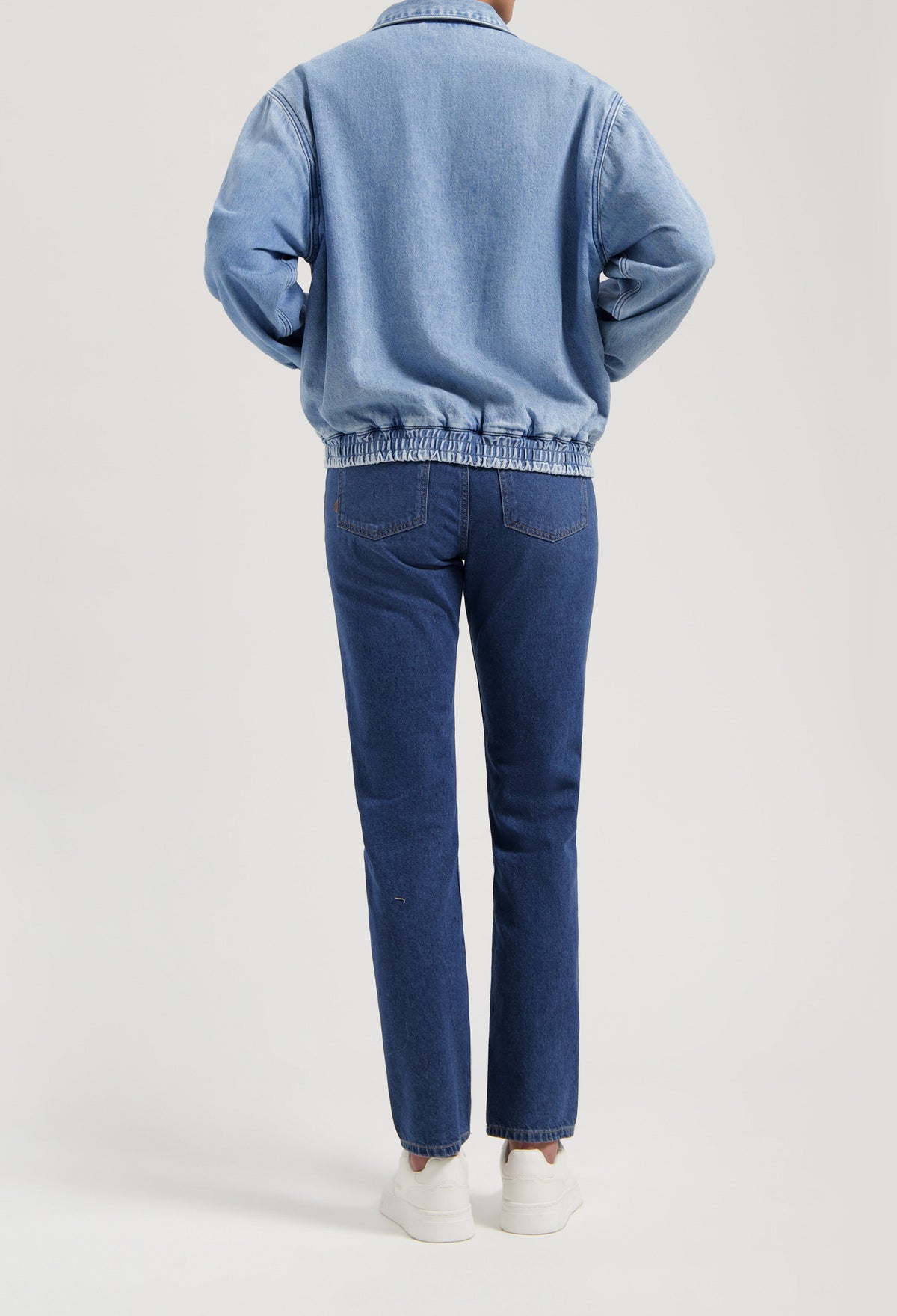 Casual blue denim jacket paired with matching blue jeans, showcasing a relaxed fit and elastic waistband design.