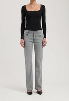 Women's gray straight-leg jeans paired with a black long-sleeve bodysuit, showcasing casual chic fashion style.