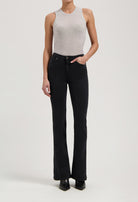 Ribbed gray sleeveless top paired with black high-waisted bootcut jeans and black ankle boots.