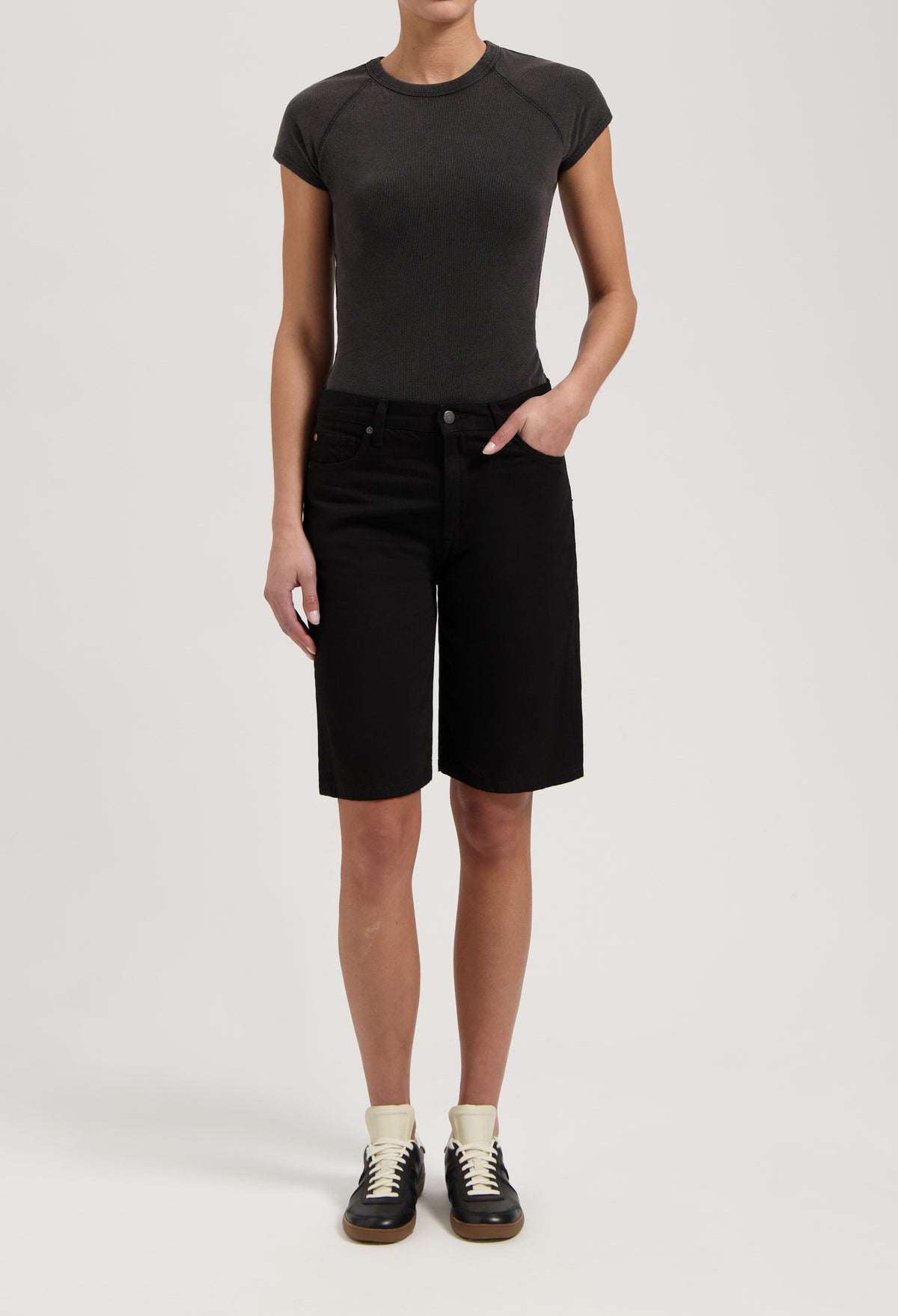 Casual black denim knee-length shorts paired with a fitted dark gray t-shirt, showcasing a relaxed summer style.