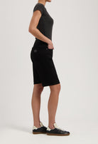 Black denim shorts paired with a fitted dark gray t-shirt, showcasing casual summer fashion with black sneakers.